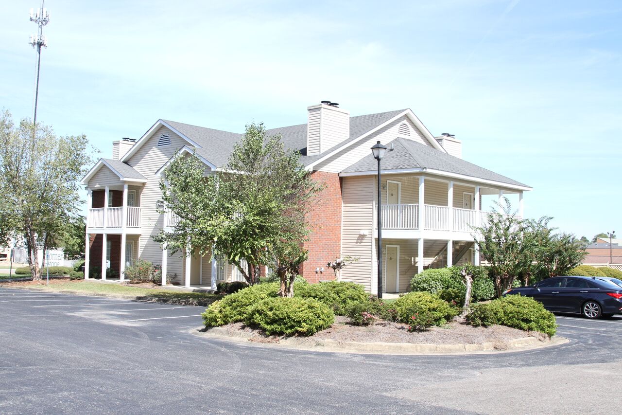 a house with a parking lot in front of it